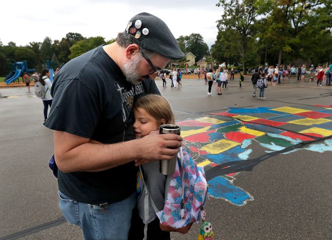 Samantha Carey, 6, hugs her father Derrick Carey as they say goodbye on the first day of school Tuesday, September 3, 2019, at Jefferson Elementary School in Appleton.