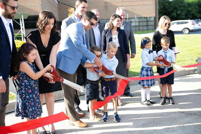 Tyler Horning, center, at Ivywood Classical Academy's ribbon cutting on Aug. 22.