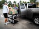 Bill Athey, left, helps John Viscuso, right, unload donations from his truck at Venue Naples on Tuesday, September 3, 2019.