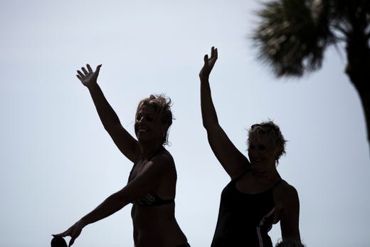 Linda Crea, left, and Chris Kozlowski, right, pose for a photo at the Naples Beach on Tuesday, September 3, 2019. They evacuated from St. Lucie on east coast of Florida last Friday. Locals and tourists continue visiting scenic spots in Naples, taking advantage of heavy winds and waves bought on by Hurricane Dorian.