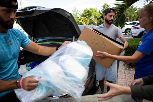 Vinny Sabatino, left, and Jerry Nestico, center, unload over 2,200 diapers donated by Peggy Moberg, president of Naples Wings of Hope, a Collier County charity that was created after Hurricane Irma, at Venue Naples on Tuesday, September 3, 2019. Venue Naples is collecting donations to send to the Bahamas in the wake of Hurricane Dorian, and will be open from 8am to 4pm Tuesday through Friday for drop-offs. Volunteers have also offered to pick up donations from residents' homes, and many local businesses have signed up to serve as additional drop-off locations. A full list of needed items and drop-off locations is available on the Venue Naples Facebook page.