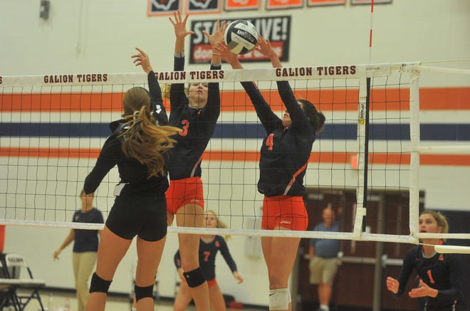 Galion's Taylor Keeran and Jaden Ivy block a tip from Clear Fork's Aubrey Bailey at the net.