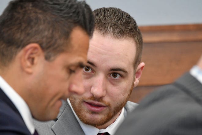 Guy Mitchell confers with his attorney Justin Weatherly before opening statements in his trial Wednesday morning.