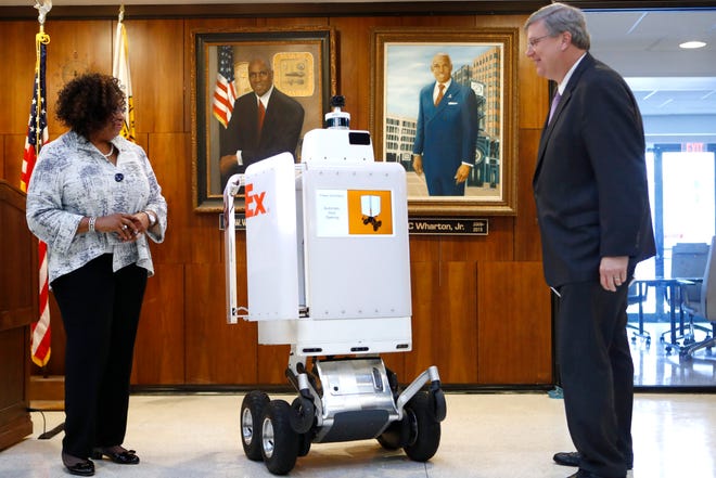 Gloria Boyland, corporate vice president of operations and service support at FedEx, introduces their delivery robot Roxo to Mayor Jim Strickland at City Hall downtown on Wednesday, Sep. 4, 2019. 