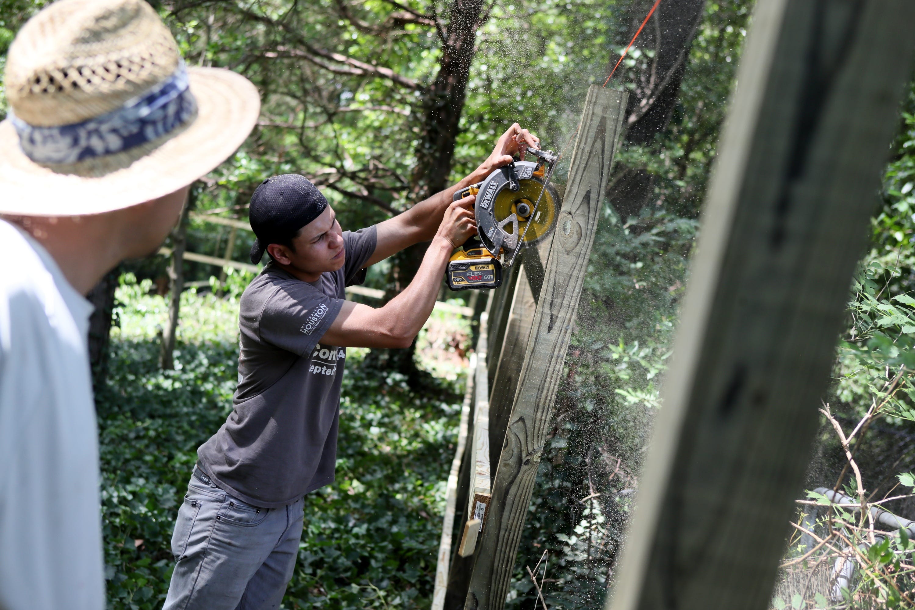 Oscar Gutierrez and a co-worker build a fence in June in a backyard in Memphis. Gutierrez joined a small construction company a few months ago with no prior experience and is learning on the job. He’s originally from Honduras and has a pending immigration court case as he seeks to remain in the United States.