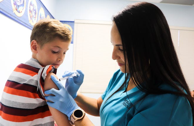 Brayden McMichael, 10, gets his annual flu shot. Medical professionals recommend that every healthy person  six months and older get the flu vaccine. A survey by Orlando Health found that a third of parents are skeptical of its  effectiveness.