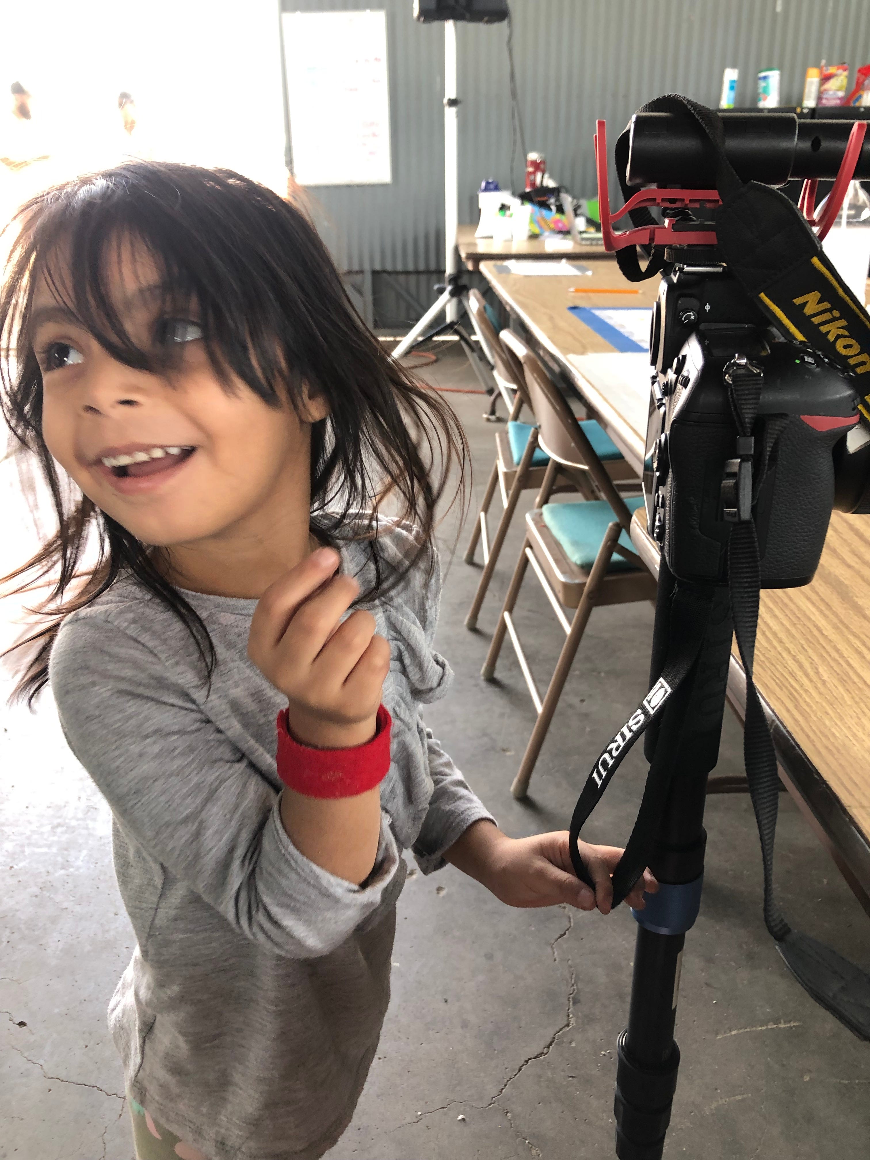 DEMING, N.M. – A migrant child plays with the camera of visual journalist Annie Rice at a migrant shelter in Deming, N.M.