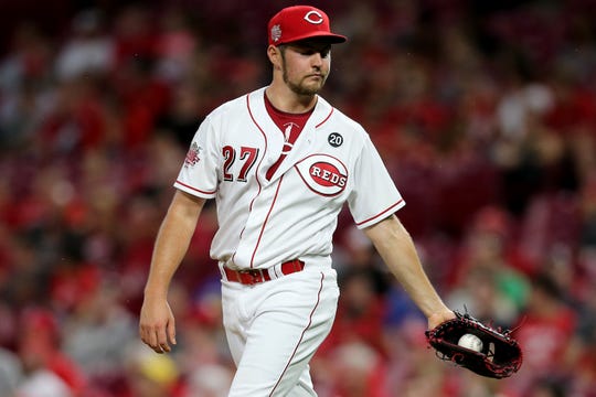 Cincinnati Reds starting pitcher Trevor Bauer (27) reacts after surrendering a two-run home run to Philadelphia Phillies first baseman Logan Morrison (8) in the fifth inning of an MLB baseball game, Wednesday, Sept. 4, 2019, at Great American Ball Park in Cincinnati. 