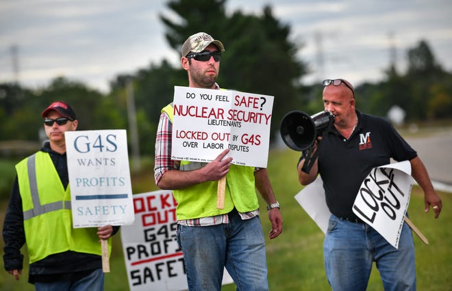 Security workers and supporters hold signs outside an entrance to the Monticello nuclear power plant Thursday, Sept. 4, 2019. About 25 members of United Security Professionals Local 2 have been locked out of the plant since midnight Saturday when their contract expired. 