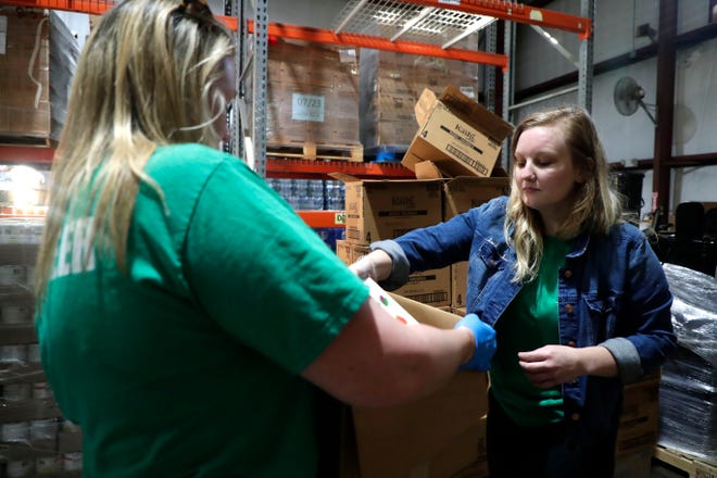 At Second Harvest Food Bank, Lana Steele places a box of cereal in one of the 400 boxes of nonperishable food being sent to areas hardest hit by Hurricane Dorian. On Feb. 14, the food bank will host a "Singles Sort" service event.