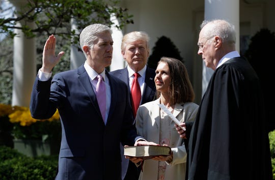 Neil Gorsuch took the oath as a Supreme Court justice in the White House Rose Garden in April 2017, accompanied by President Trump,  Associate Justice Anthony Kennedy, and Gorsuch's wife, Louise.