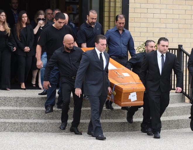 Pallbearers carry the casket of Jimmy Aldaoud, a refugee who died after he was deported to Iraq, after a memorial service Friday at the Mother of God Chaldean Catholic Church in Southfield.