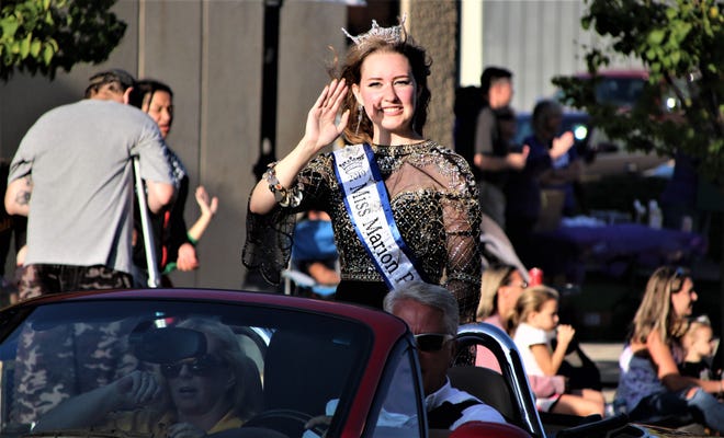Miss Popcorn 2019 Payton Baxter leads a long line of festival royalty down Center Street during the Marion Popcorn Festival Parade.