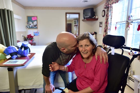 Glenn Prettitore kisses his wife Kerrie, a 42-year-old mother of three who was diagnosed with colon cancer in February 2014, is now brain damaged and in a semi conscious state after a single chemotherapy treatment. Kerrie, unknown at the time, was born with DPD Deficiency, a rare genetic disorder which dramatically increases risk factors for chemotherapy. She now resides at Genesis nursing home in Ridgewood, and her husband Glenn, a physical therapist himself works out with her on daily basis. This photo was taken 12/12/15.