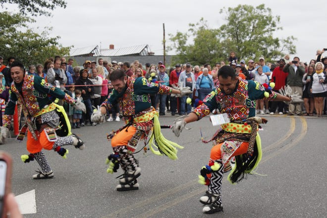 Tinkus San Simon dancers lead the kickoff parade down South Division Street at the National Folk Festival 2019 on Sept. 6.
