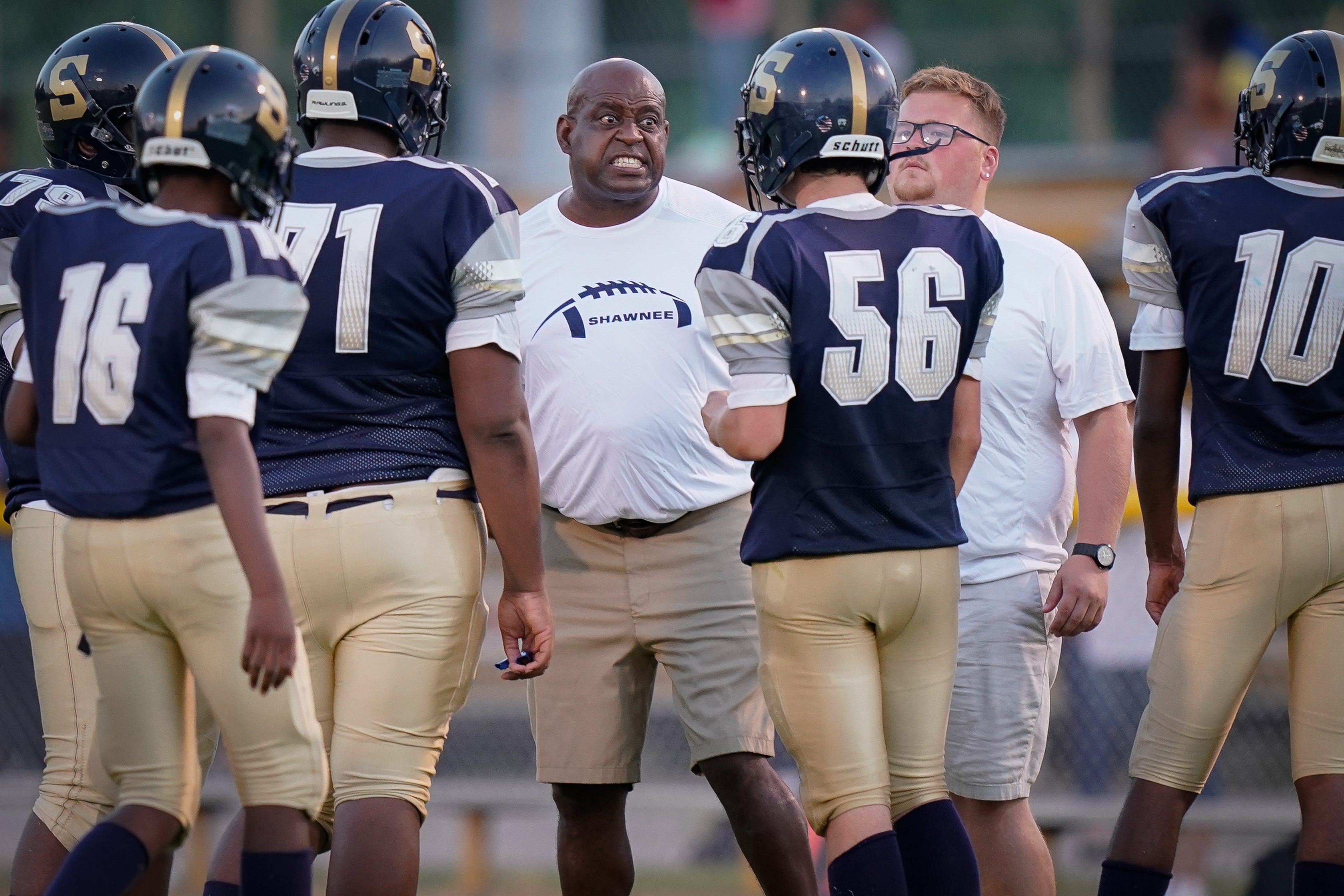 Academy @ Shawnee head football coach Kenneth Walker instructs players during the game against Seneca in Louisville on Sept. 6, 2019.