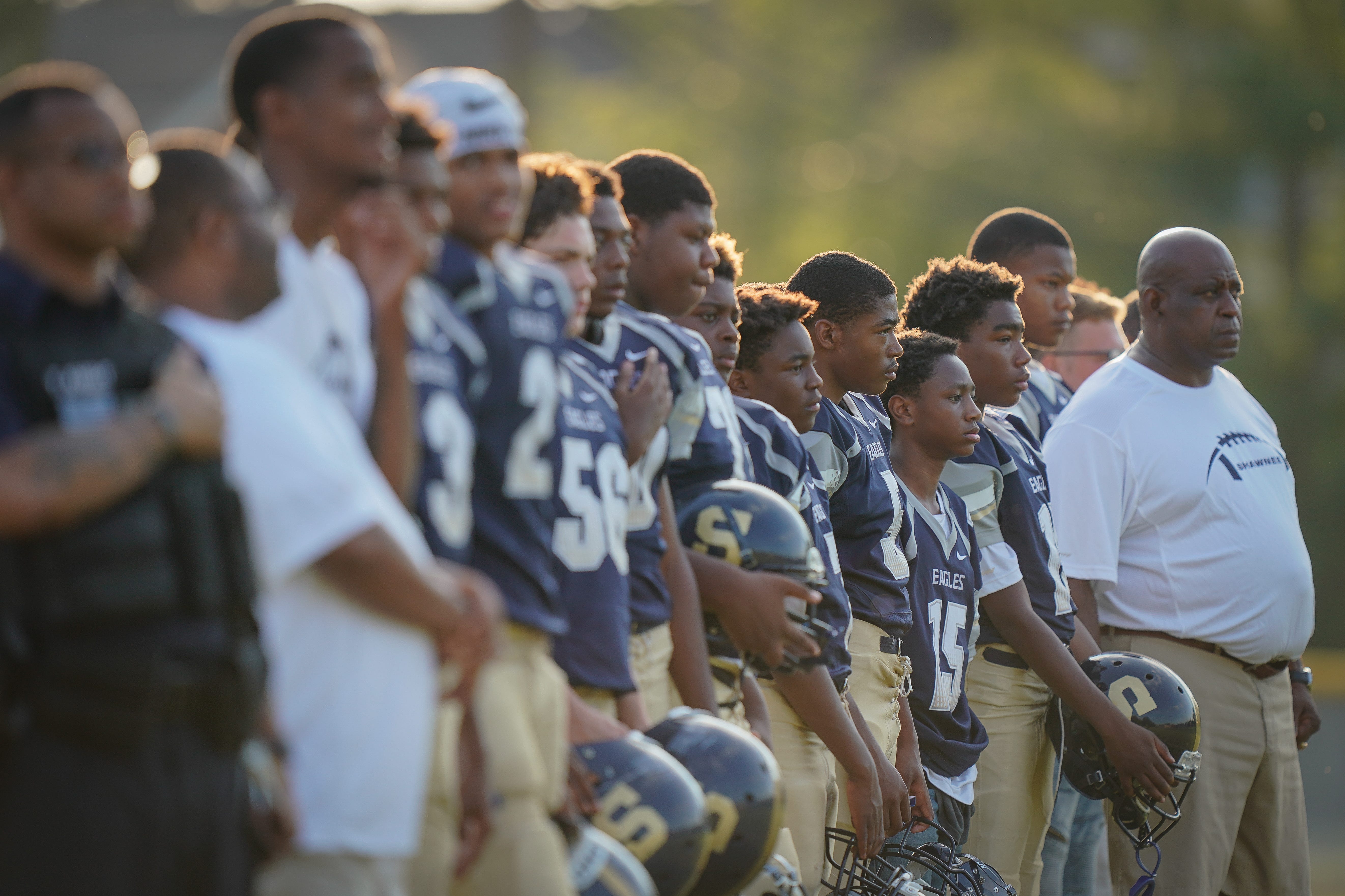 Academy @ Shawnee players stand during the national anthem before the football game played against Seneca in Louisville on Sept. 6, 2019.