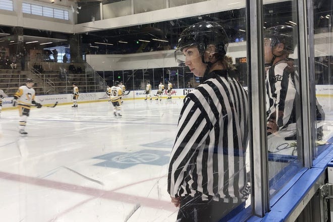 Linesman Kirsten Welsh watches at center ice as Pittsburgh Penguins and Boston Bruins players take the ice to prepare to play in the Sabres prospects hockey tournament, Friday, Sept. 6, 2019, in Buffalo, N.Y. Welsh is one four female officials selected to be the first women to work as on-ice officials at several prospect tournaments taking place across the country this weekend. The other three other women selected were Katie Guay, Kelly Cooke and Kendall Hanley.  Photo by John Wawrow