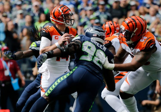 Cincinnati Bengals quarterback Andy Dalton (14) drops back in the pocket in the first quarter of the NFL Week 1 game between the Seattle Seahawks and the Cincinnati Bengals at CenturyLink Field in Seattle on Sunday, Sept. 8, 2019.