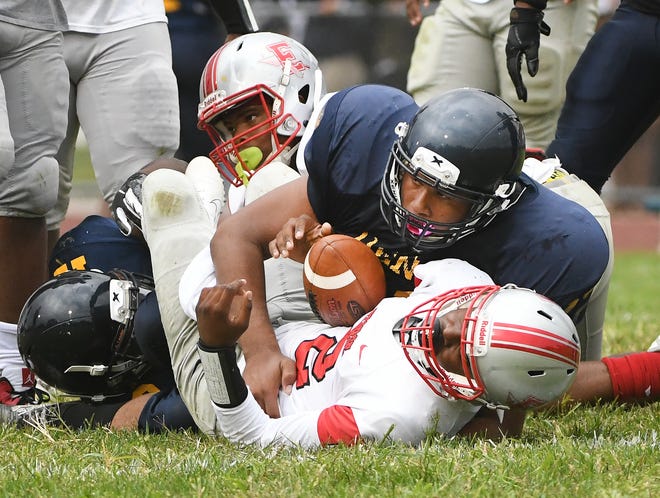 Detroit Denby's Mark Haygood sacks Ecrose's Darius Cross in the second quarter Friday. Denby is No. 5 in The Detroit News' rankings of Detroit teams.