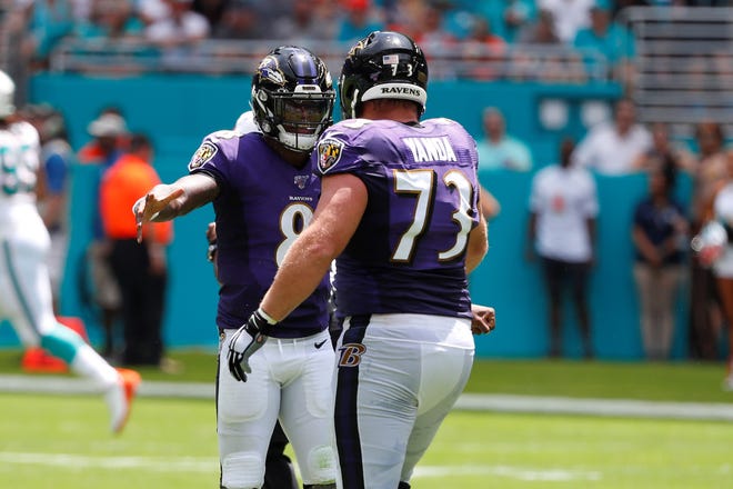 Baltimore Ravens quarterback Lamar Jackson (8) celebrates a touchdown with offensive guard Marshal Yanda (73), during the first half at an NFL football game against the Miami Dolphins, Sunday, Sept. 8, 2019, in Miami Gardens, Fla. (AP Photo/Wilfredo Lee)