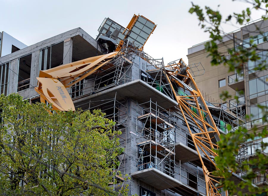 A toppled building crane is draped over a new construction project after Hurricane Dorian swept through the area in Halifax, Nova Scotia, on Sunday, Sept. 8, 2019.