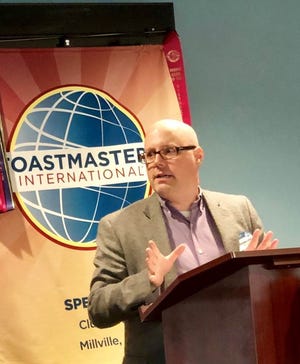 Chris Loftin, treasurer and vice president of education, Speak E-Z Toastmasters, speaks at a club meeting.