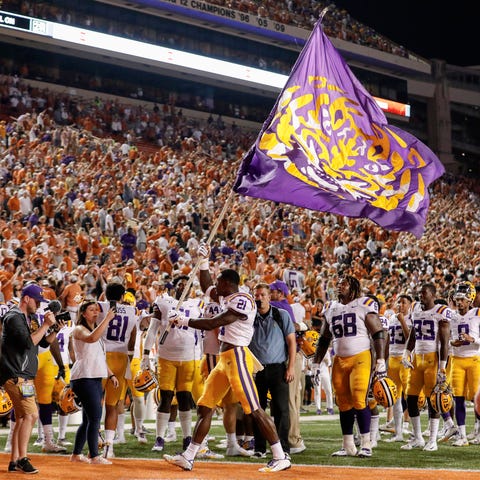 LSU's Kenan Jones celebrates with a flag after the