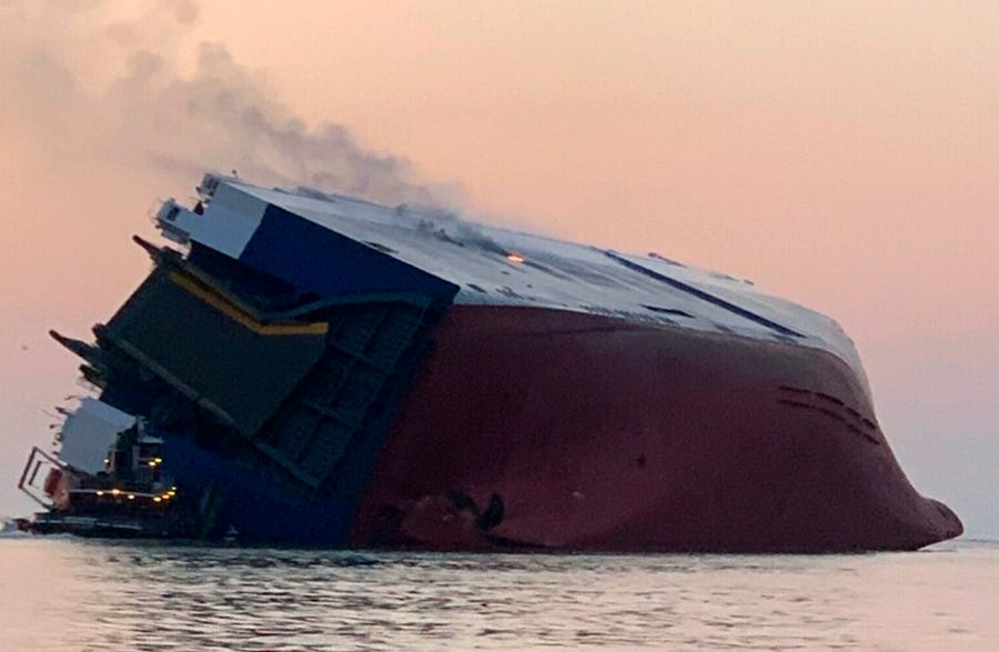 Coast Guard crews and port partners respond to an overturned cargo vessel with a fire on board, Sept. 8, 2019, in St. Simons Sound, Ga.
