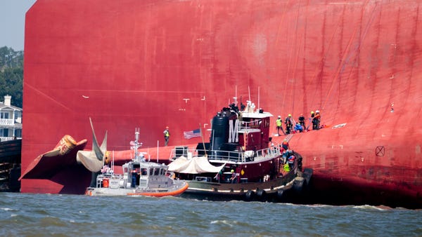 Rescuers work near the stern of the vessel Golden 