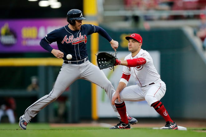 Atlanta Braves first baseman Freddie Freeman (5) steps back to first against Cincinnati Reds first baseman Joey Votto (19) on pick off attempt in the third inning of the MLB National League game between the Cincinnati Reds and the Atlanta Braves at Great American Ball Park in downtown Cincinnati on Wednesday, April 24, 2019