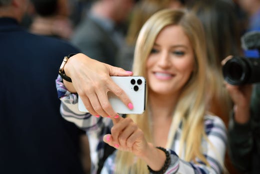A woman tries out a new Apple 11 Pro during an Apple product launch event at Apple's headquarters in Cupertino, California on Tuesday, on September 10, 2019. - Apple unveiled its iPhone 11 models Tuesday, touting upgraded, ultra-wide cameras as it updated its popular smartphone lineup and cut its entry price to $699. (Photo by Josh Edelson / AFP)JOSH EDELSON/AFP/Getty Images ORG XMIT: Apple exp ORIG FILE ID: AFP_1K678P