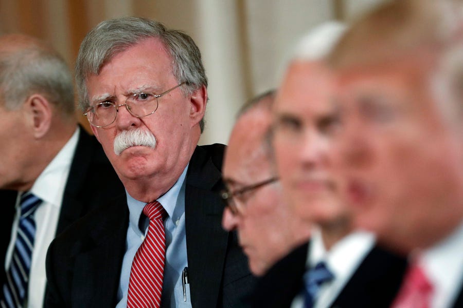 In this April 18, 2018 file photo, National security adviser John Bolton, left, listens to President Donald Trump, far right, speak during a working lunch with Japanese Prime Minister Shinzo Abe at Trump' s private Mar-a-Lago club in Palm Beach, Fla. Trump tweeted Tuesday that he told Bolton Monday night that his services were no longer needed at the White House.