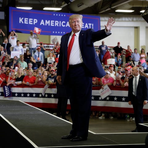 President Donald Trump waves to the crowd after a 