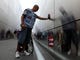 Nelson Rivera touches his hand to the name of his son, Isaias Rivera, whose name is on the wall at the Empty Sky Memorial in Jersey City, NJ on September 11, 2011. Nelson was getting ready to leave the memorial after putting up a flag near his son's name. Isaias, who lived in Jersey City, worked as a financial advisor in Tower I of the World Trade Center and was 23 at the time of his death. The Empty Sky Memorial is dedicated to residents of New Jersey who died on September 11, 2001. 