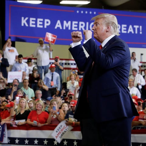 President Donald Trump gestures to the crowd at a 