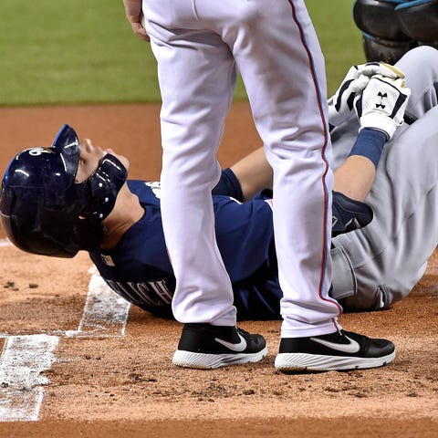 Christian Yelich lays on the ground in pain after 