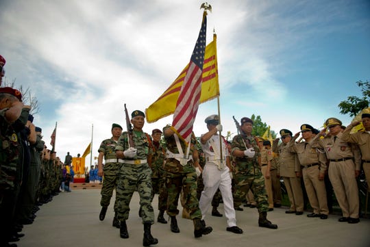 The South Vietnamese and American flags fly at a commemoration of the fall of Saigon in Westminster, California, on April 30, 2015.