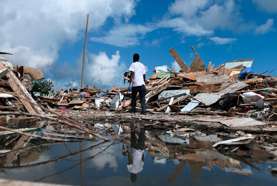 A man salvages debris in Marsh Harbour, Bahamas, on Sept. 10, 2019, one week after Hurricane Dorian.