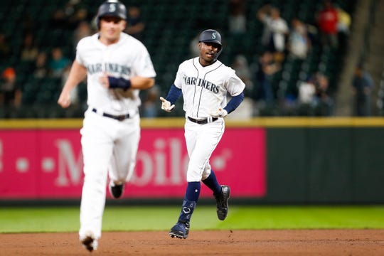 Seattle Mariners right fielder Kyle Lewis (30) reacts as he runs the bases after hitting a three-run home run against the Cincinnati Reds during the seventh inning at T-Mobile Park on Wednesday night.