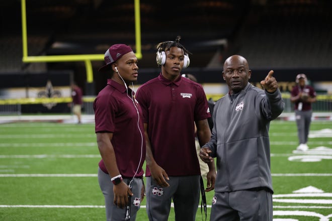 Mississippi State cornerbacks coach Terrell Buckley (far right) instructs freshmen corners Martin Emerson Jr. (middle) and Jarrian Jones (far left) during a walk through at Mercedes-Benz Superdome.