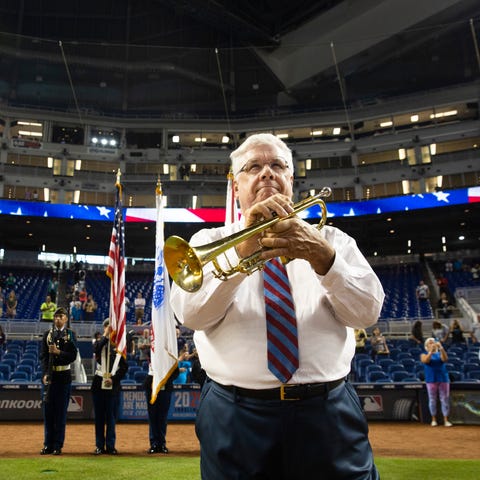 Jim Doepke performs national anthem on his trumpet