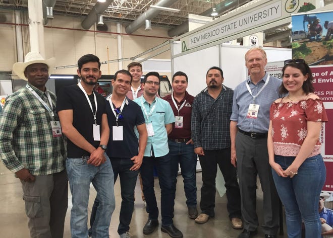 The New Mexico State University College of Agricultural, Consumer and Environmental Sciences representatives worked a booth at the Chihuahua Agro Expo in Chihuahua City, Mexico, and met with prospective students. From left; Soum Sanogo, College of ACES professor; Alonso Garcia and Jorge Fernandez, ACES alumni; Mark Sheely (back row), program coordinator of the Water Resource Research Institute; Jorge Preciado and Joaquin Figueroa, ACES graduate students; a prospective student; Sam Fernald, professor of Watershed Management and director of Water Resources Research Institute; and a second prospective student.