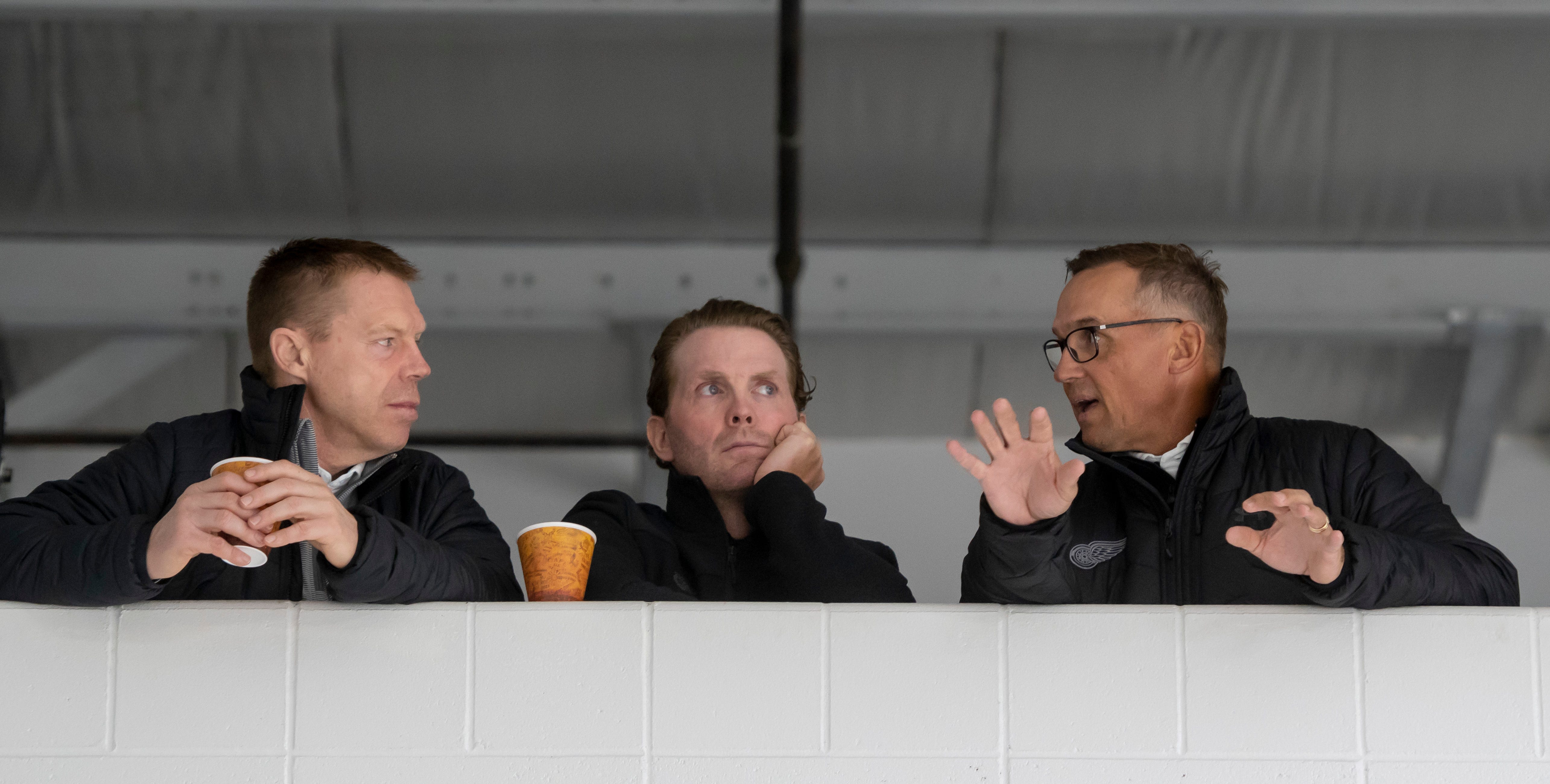 (From left) Director of Amateur Scouting Kris Draper, Assistant Director of Player Development Dan Cleary, and General Manager Steve Yzerman chat during the Red Wings training camp at Centre Ice Arena, in Traverse City.  All three were former players.