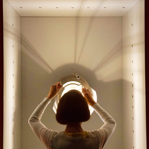A woman uses an interactive light model during the