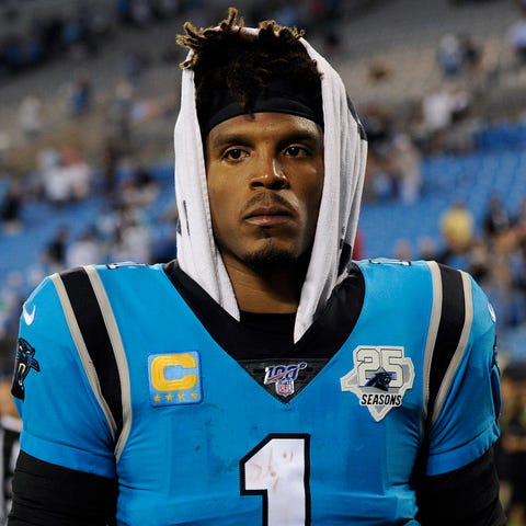 Cam Newton leaves the field after losing.