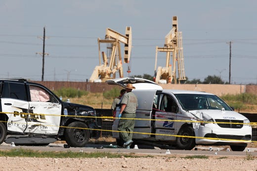 Law enforcement officials process the crime scene Sept. 1, 2019, in Odessa, Texas, from Saturday's shooting which ended with the alleged shooter being shot dead by police in a stolen mail van, right.