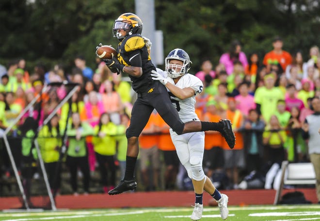 Jayden Bellamy of St. John Vianney hauls in a long pass in front of Matthew Grab of Middletown South in a game in Holmdel on Sept. 13, 2019. Bellamy transferred to Bergen Catholic.