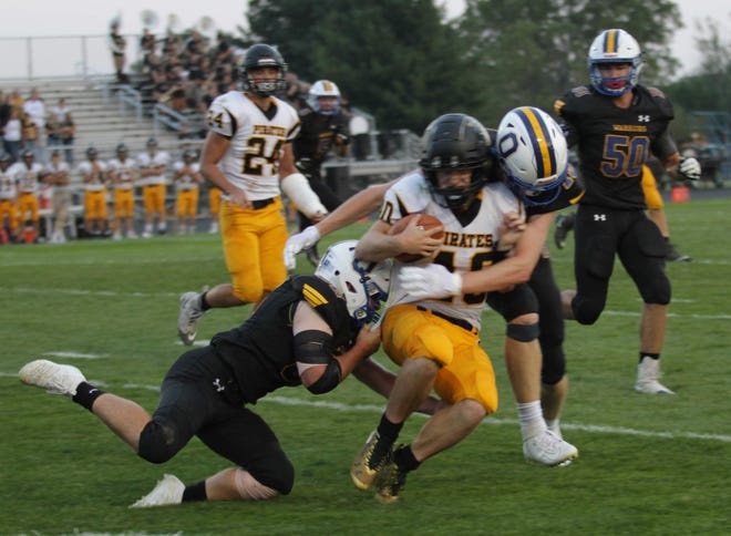 Two Ontario defenders bring down a Black River ballcarrier Friday night in a game that was completed on Saturday morning.
