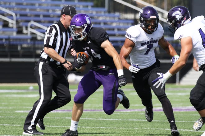Thuro Reisdorfer of USF sprints past two Winona State defenders during Saturday's game at Bob Young Field in Sioux Falls.